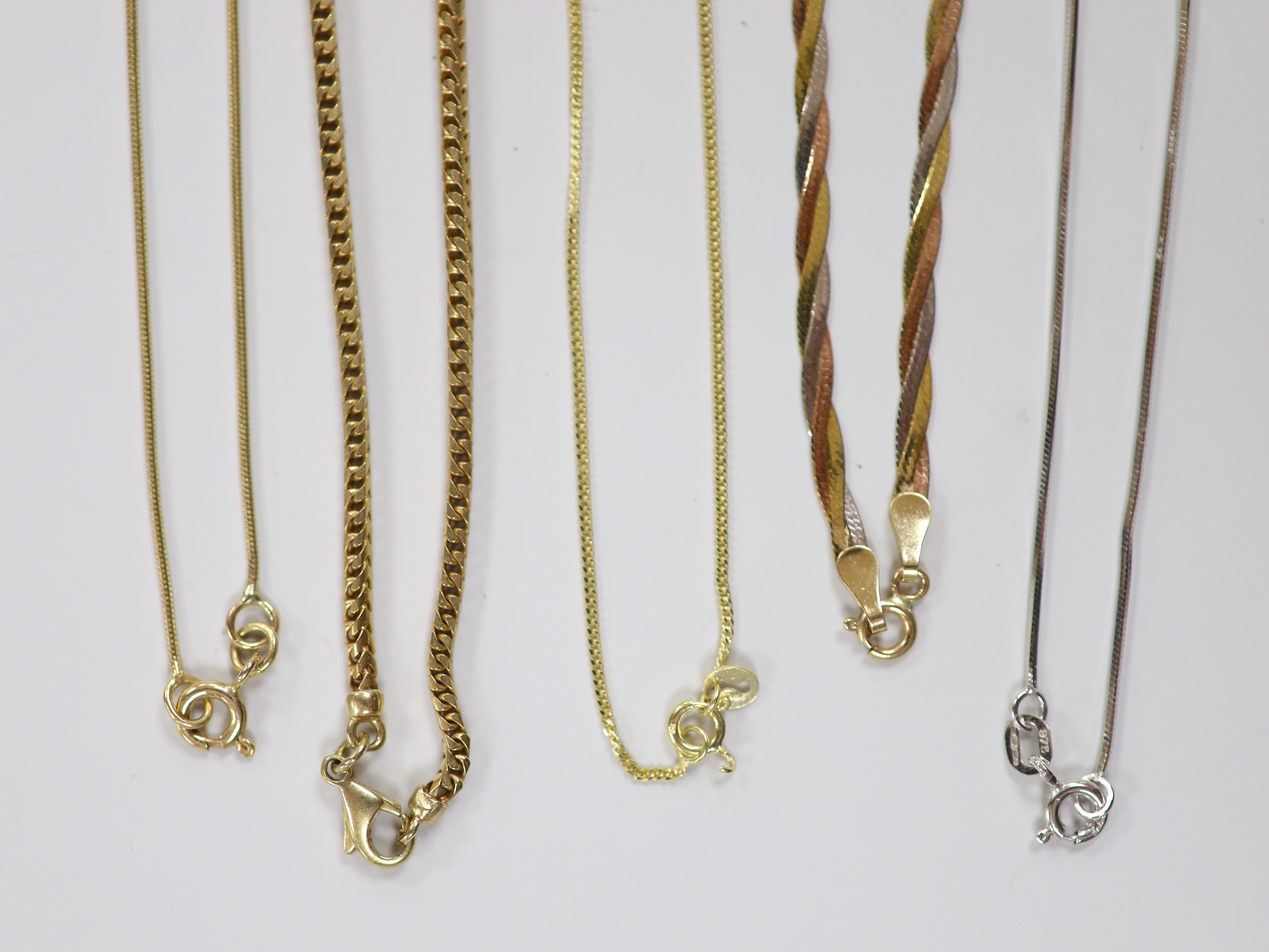 Four assorted modern 9ct gold chains including white gold and one 375 chain, longest 44cm, 19.6 grams.